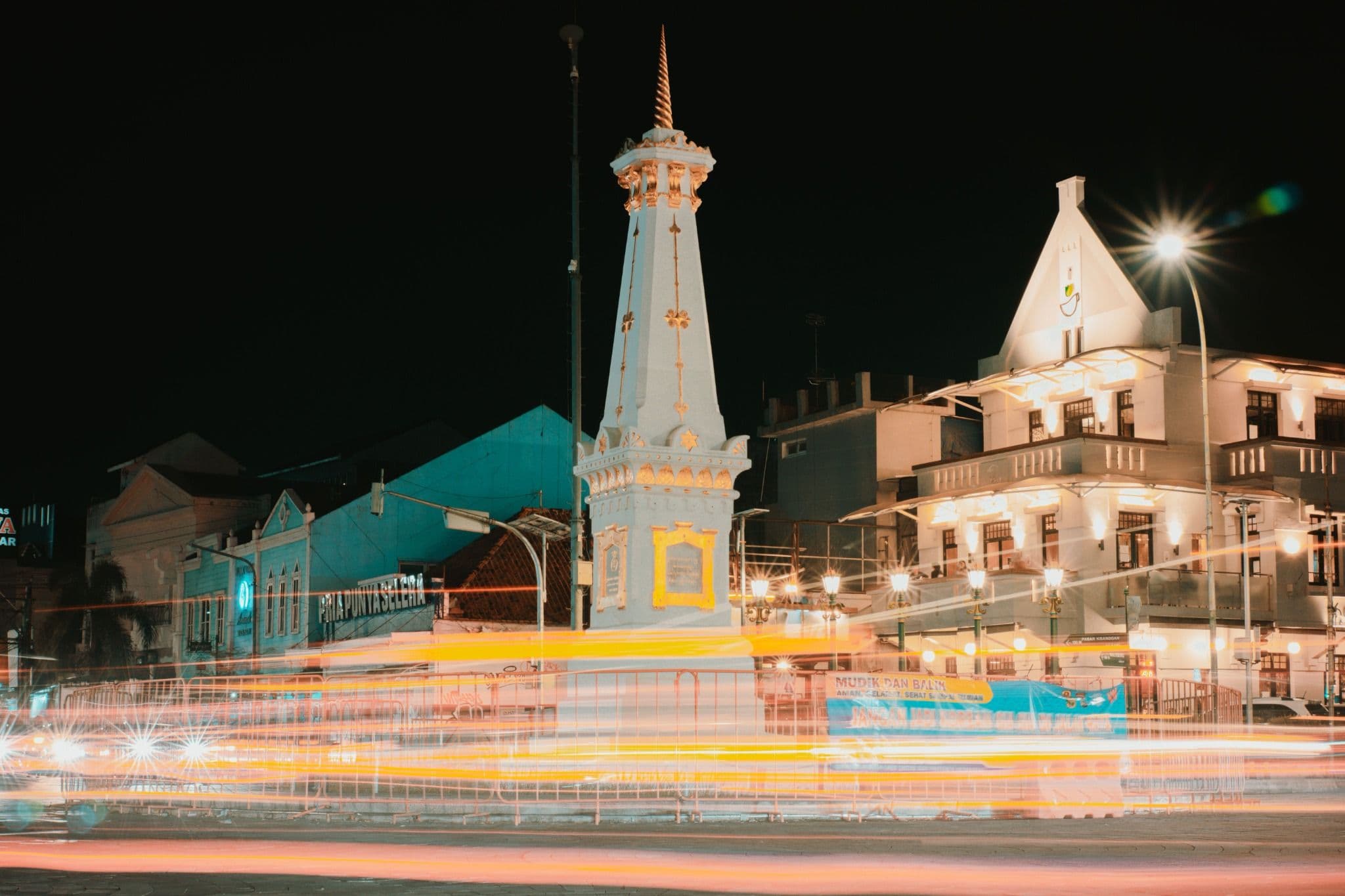 Tugu Yogyakarta illuminated at night with light trails crossing the surrounding streets