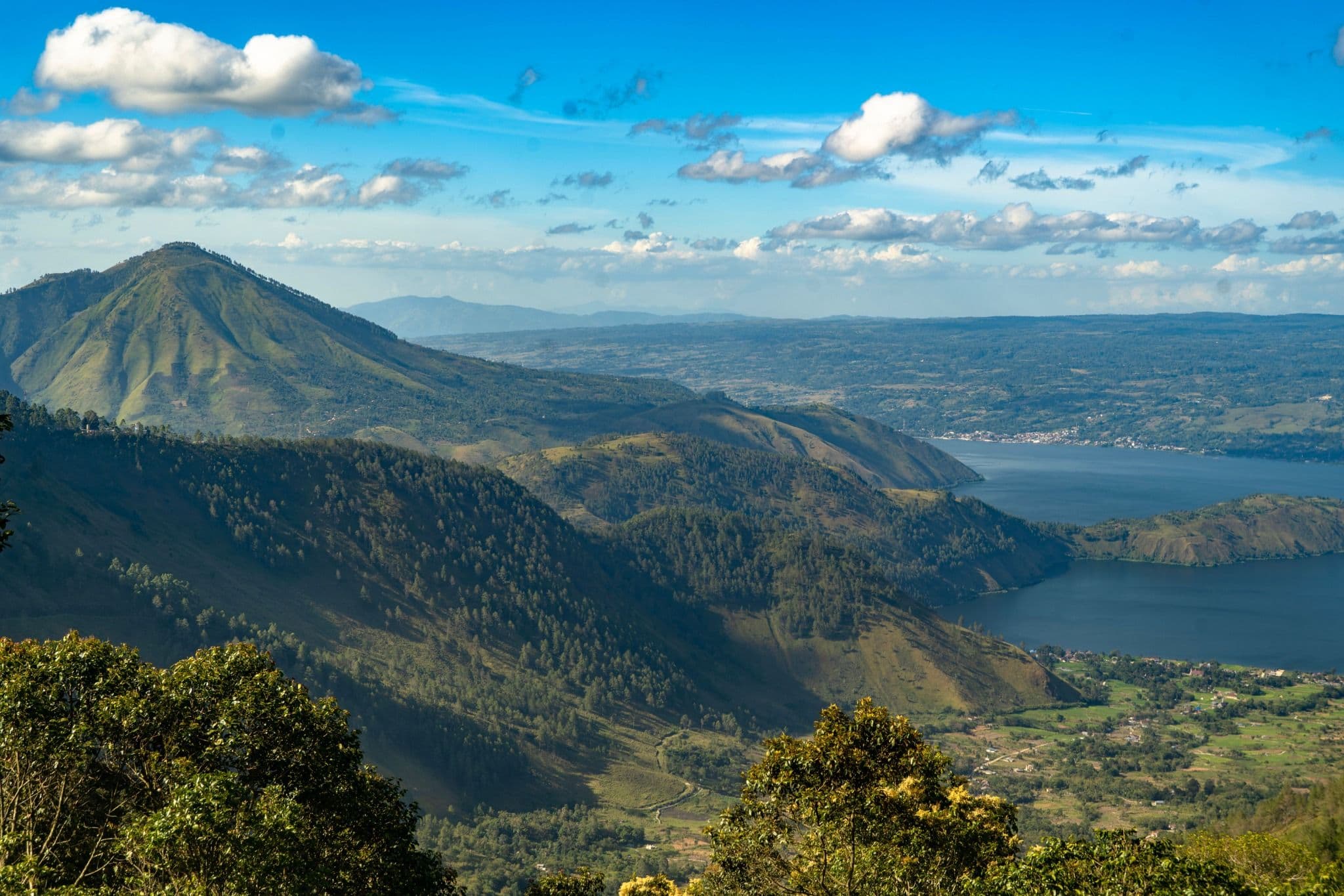 Wide view across Lake Toba, volcanic hills and highland landscape in North Sumatra