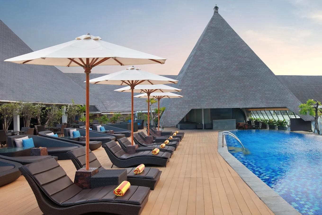 Rooftop swimming pool and sun loungers at The Kuta Beach Heritage Hotel Bali.