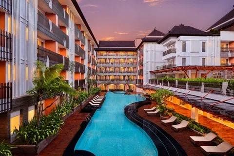 Outdoor swimming pool surrounded by the hotel buildings at Fairfield by Marriott Bali Kuta Sunset Road.